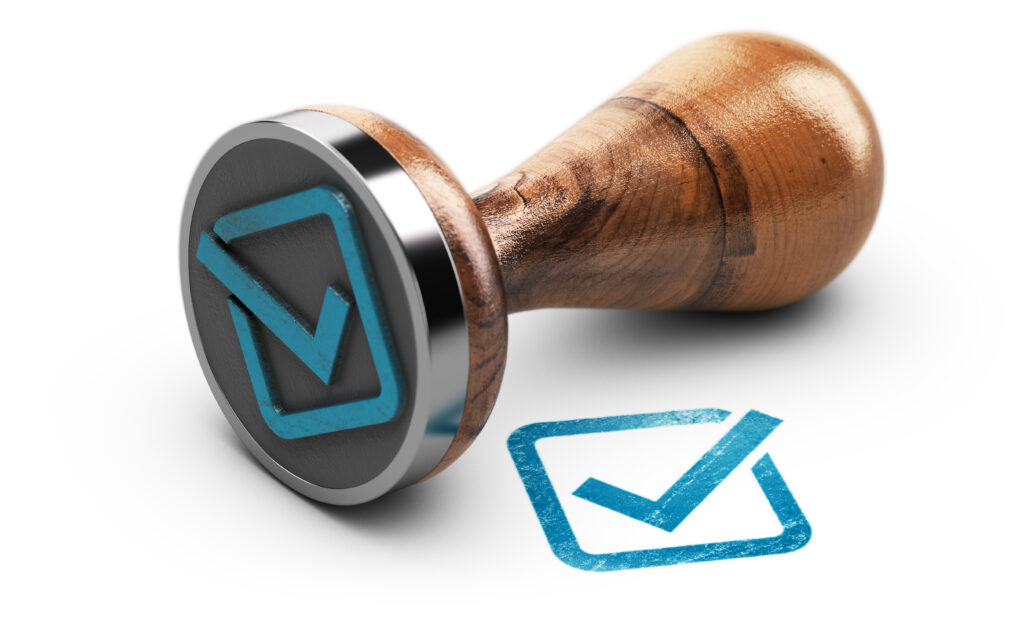 Blue check mark and rubber stamp over white background.